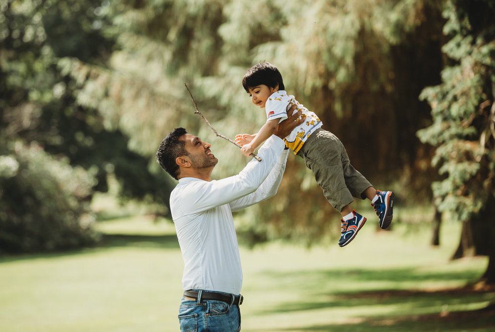dad flinging 2 year old son in air with love
