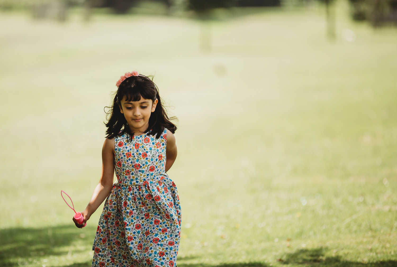 little girl of 4 walking confidently in a park