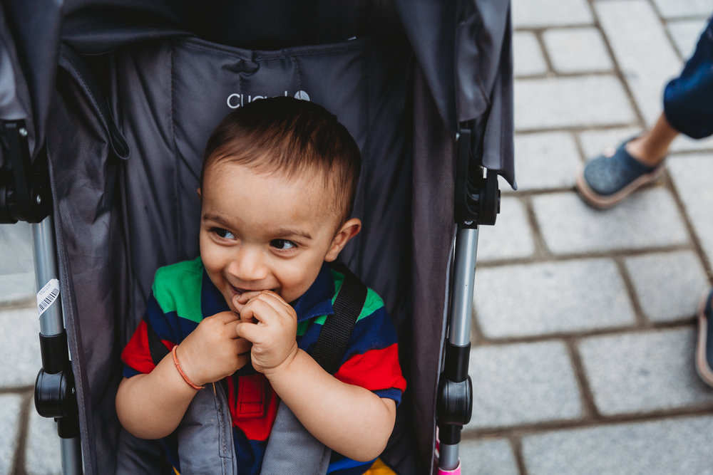 boy smiling with glee in colourful tshirt