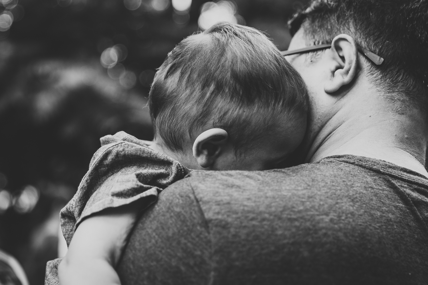 boy enjoying in dad's arms