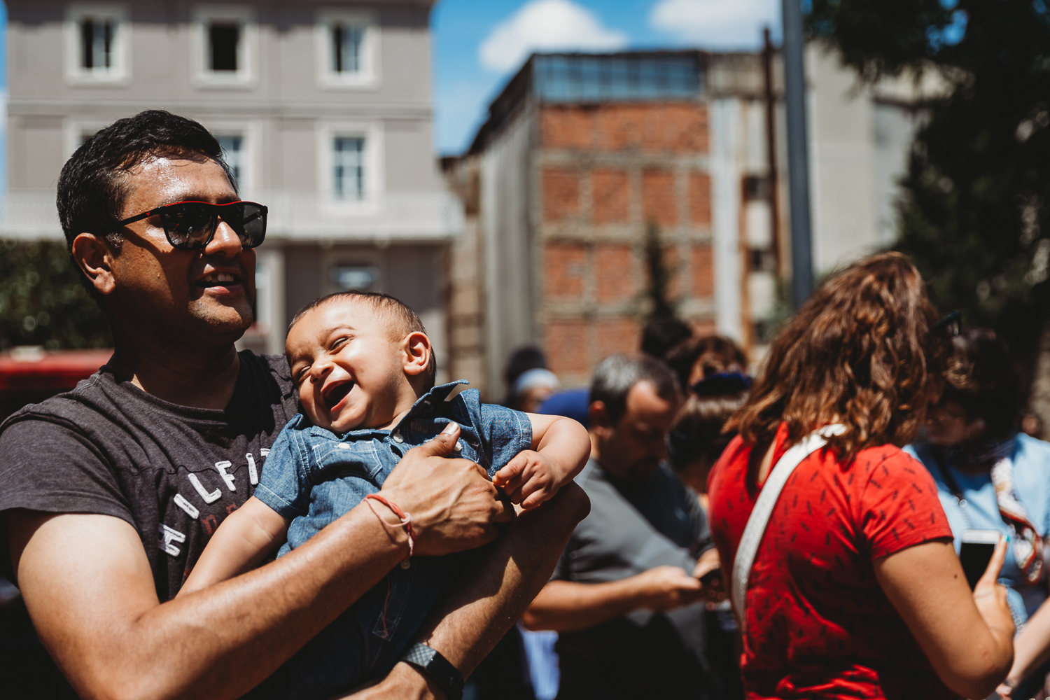 boy laughing in dad's arms on vacation