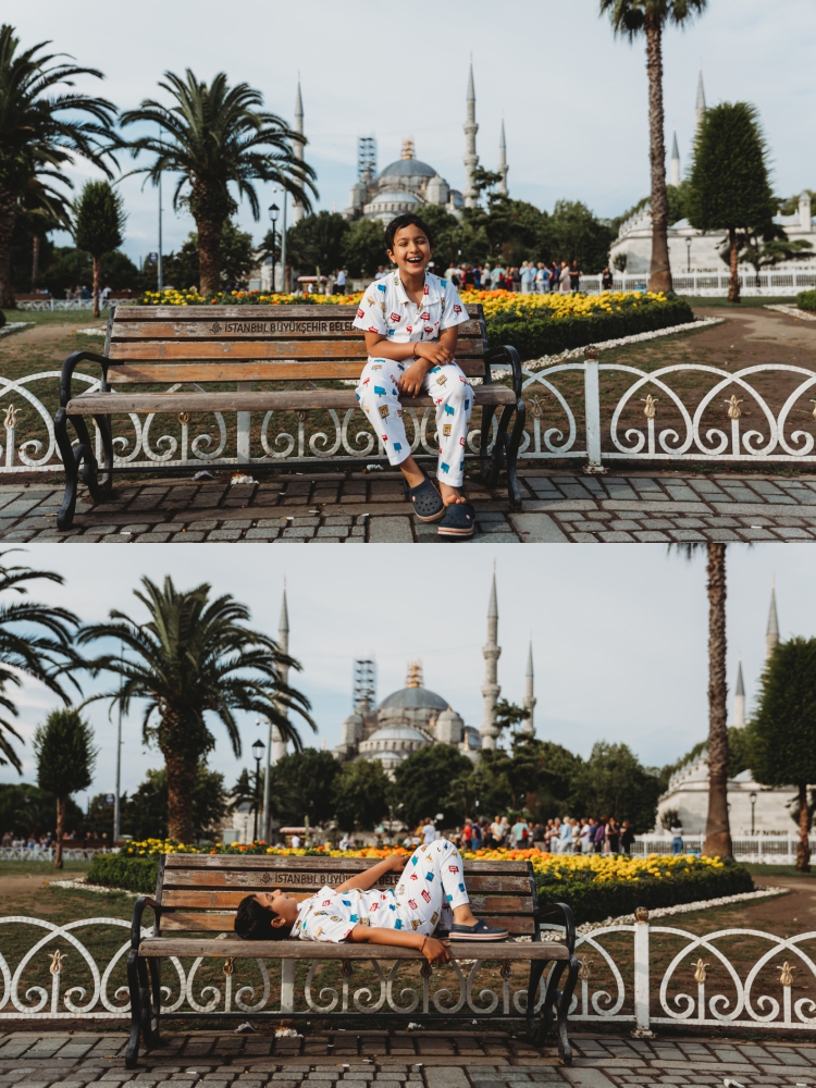 7 year old boy laughing in front of blue mosque istanbul