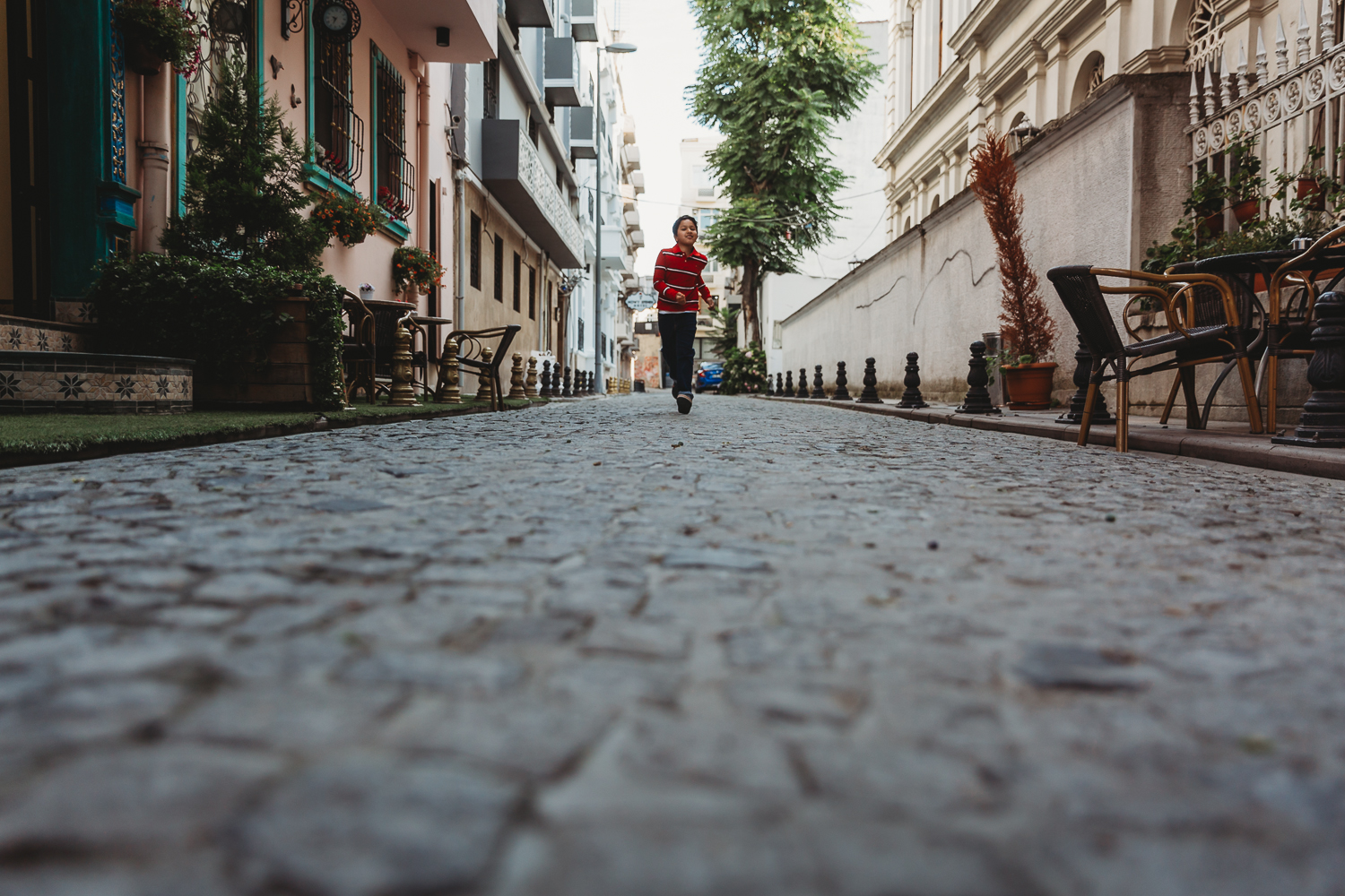 boy running on cobbled streets