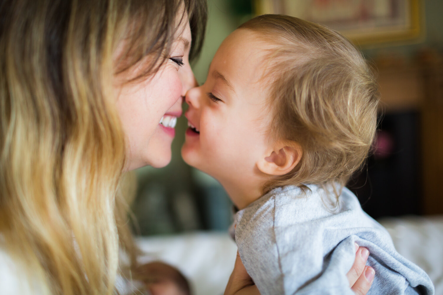 Mum and baby girl laughing at home