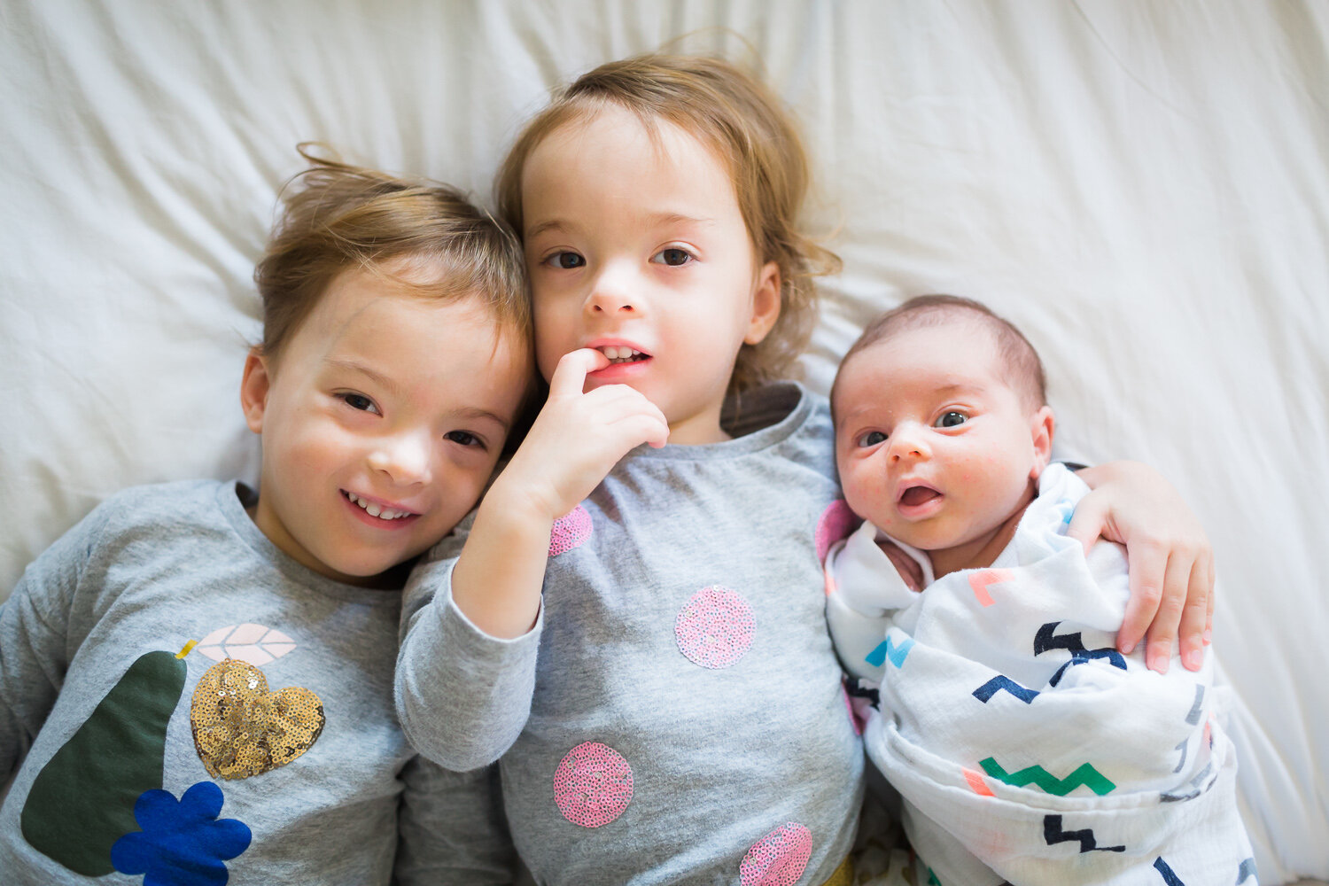 three sweet sisters with newborn baby at home in edgbaston