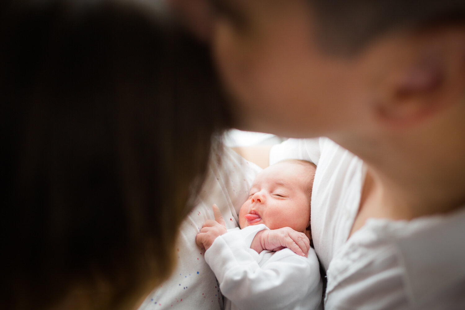 new parents cuddling newborn at home in birmingham