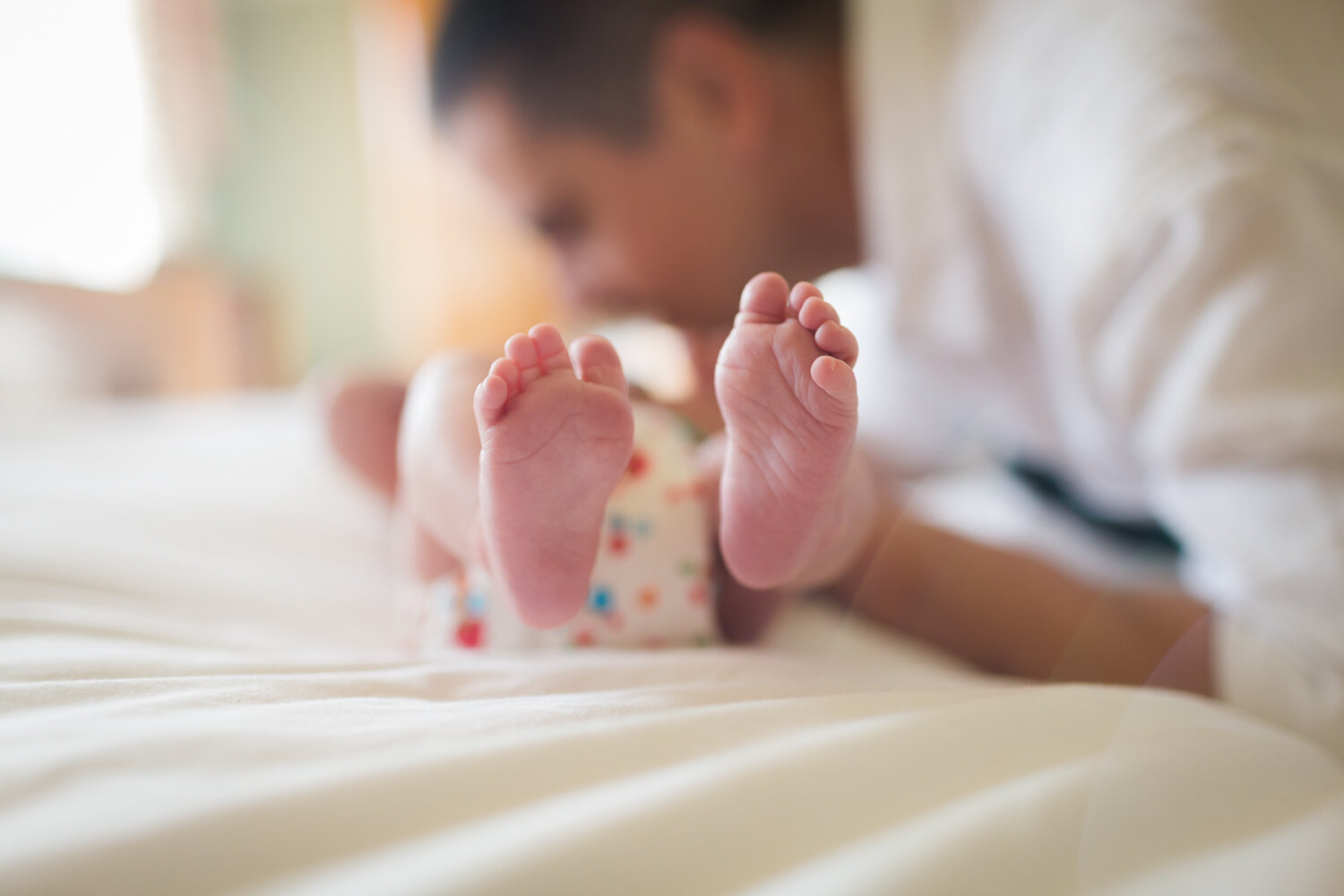 Father cuddling newborn baby at home in edgbaston, birmingham