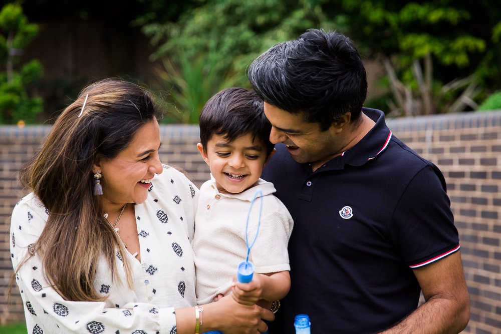 In-Home Family Photo Session In Wimbledon with family spending time in their garden