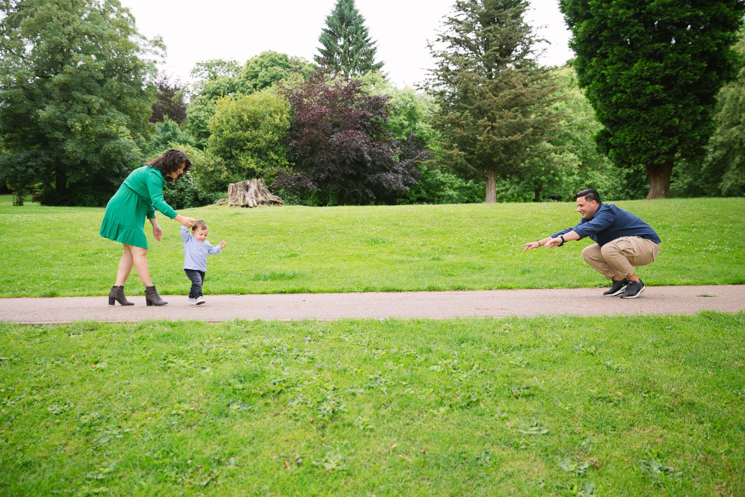 One year old showing off new walking skills in outdoor family photoshoot in wimbledon