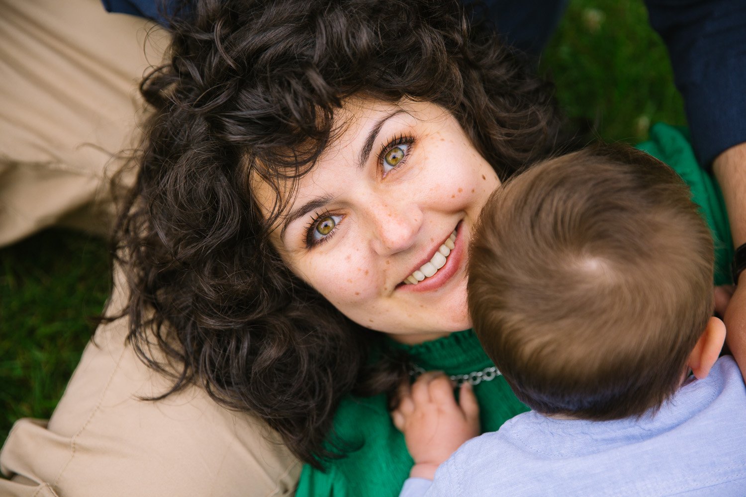 Mum happily looks at the camera in outdoor family photoshoot in wimbledon