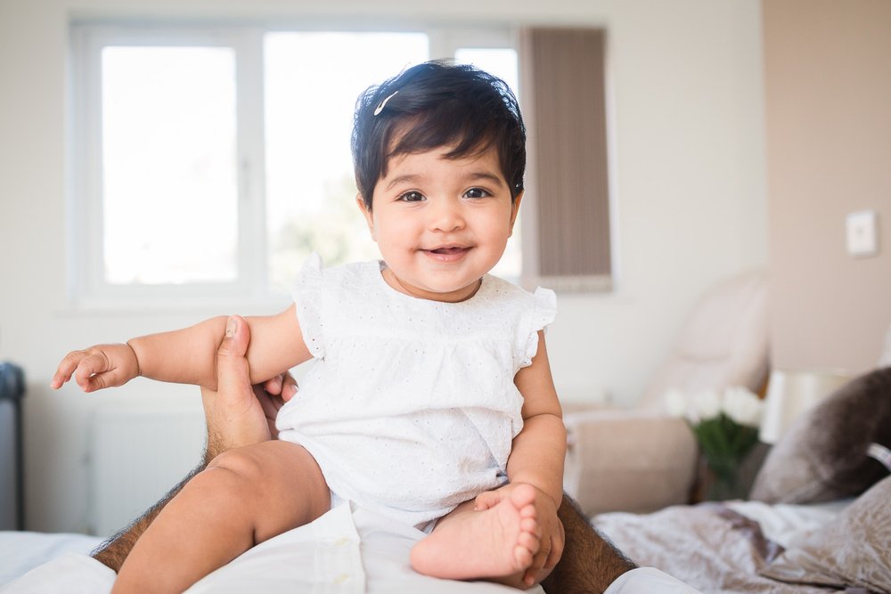 Wimbledon Family photographer captures 6 month old baby enjoying at home