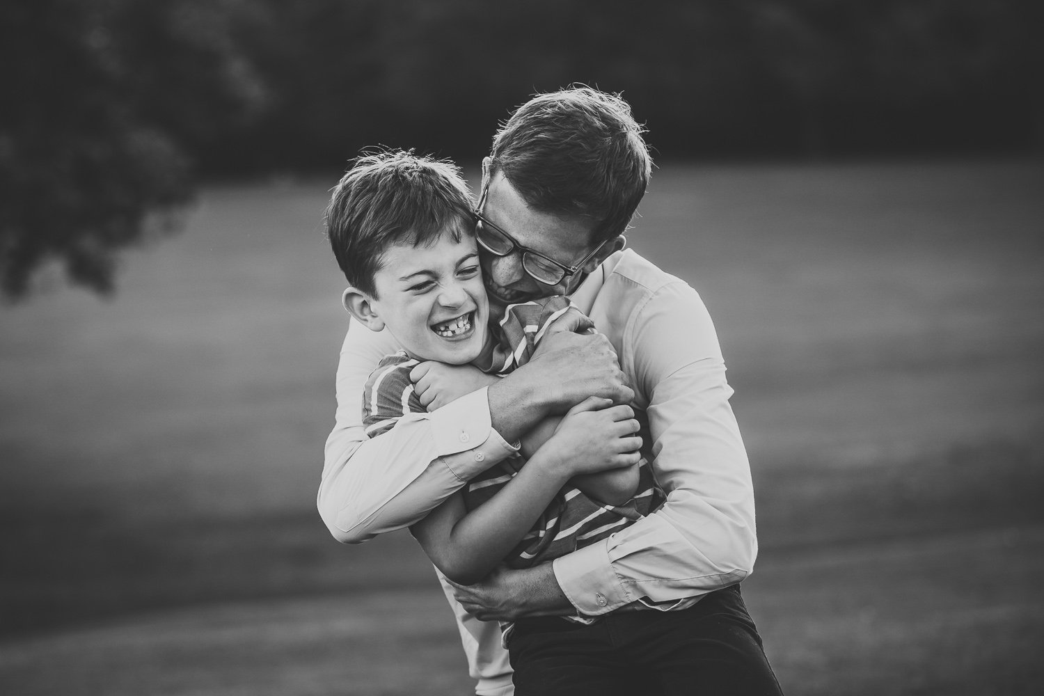 Wimbledon Family Photographer captures father giving a tight hug to son