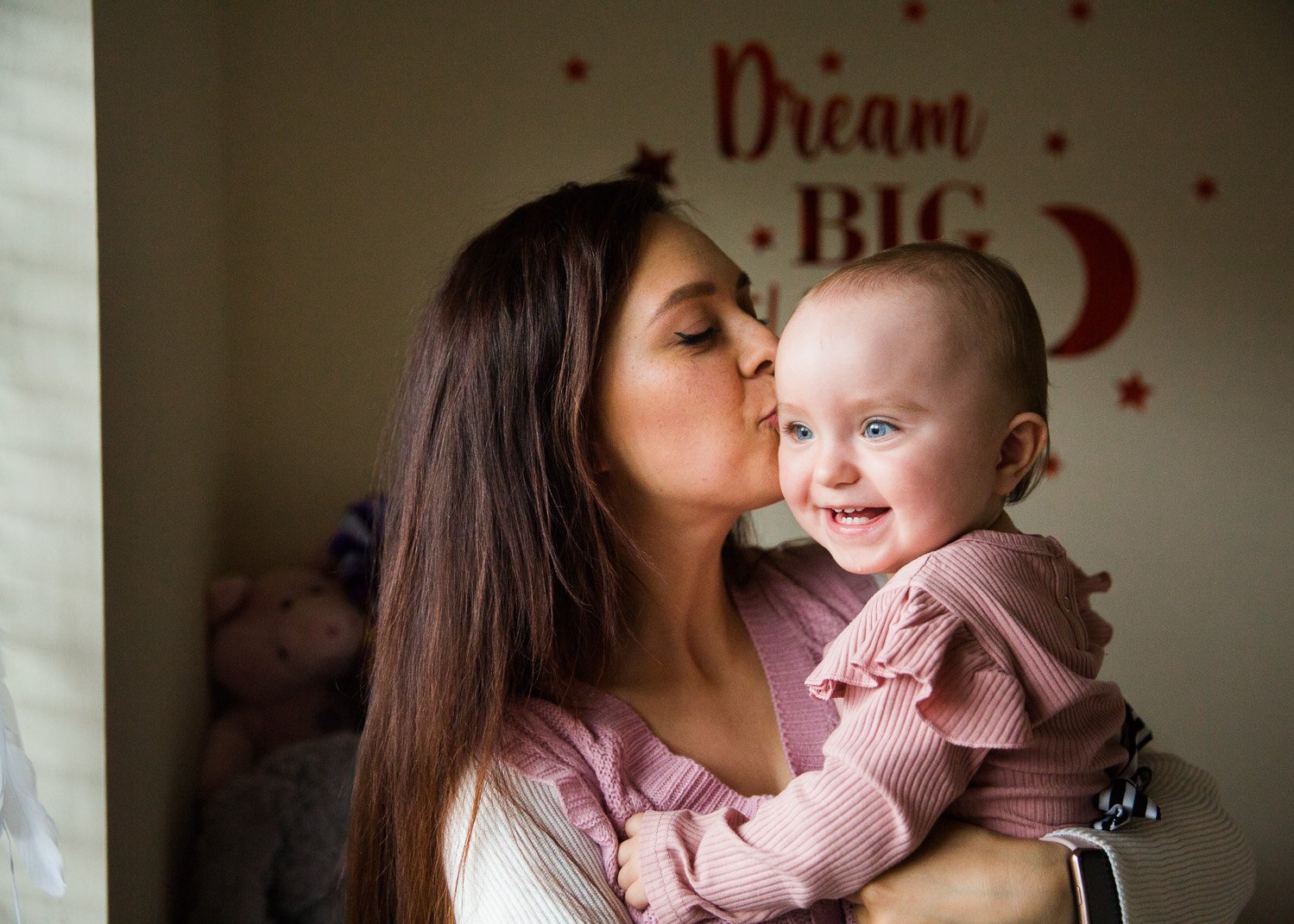 Wimbledon Family Photographer captures Mum kissing Baby daughter at home