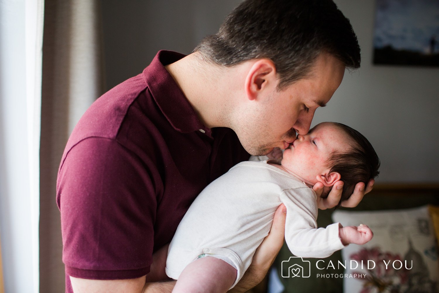 dad kissing newborn on the lips in wimbledon