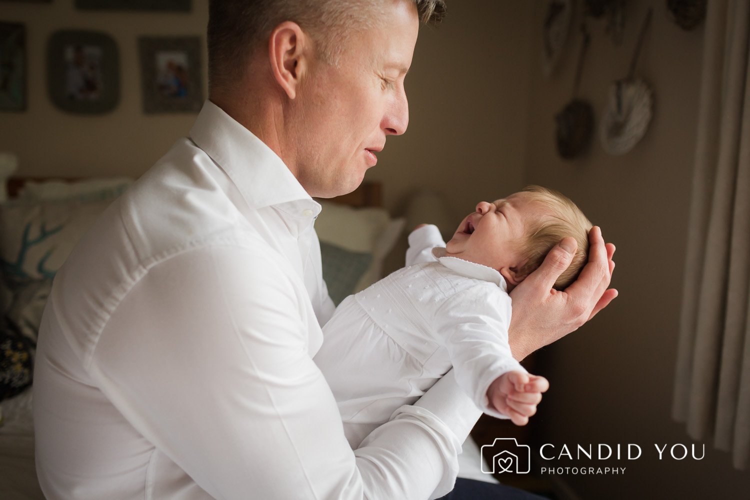 dad almost crying when newborn cries during photoshoot