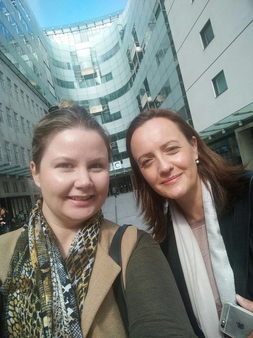 Two women in front of building