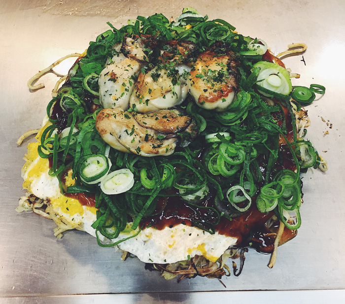 Fresh, huge oysters on my okonomiyaki from Takenoko in the famous Okonomimura, Hiroshima.