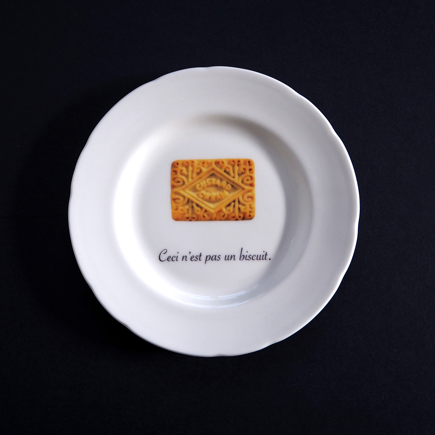 Ceci n'est pas un biscuit - custard cream on a fine English bone china plate by TIME AND TOAST