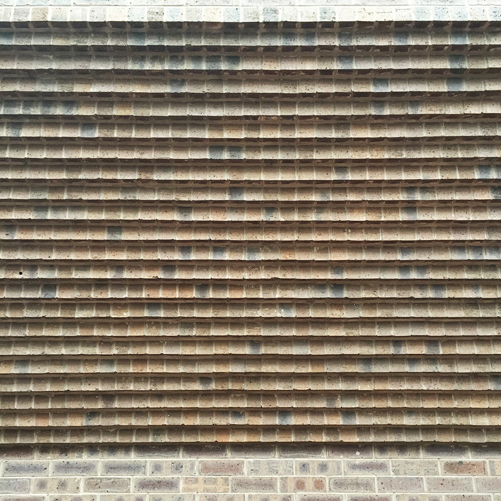 A common brick construction method used to achieve a cantilever above the sidewalk.