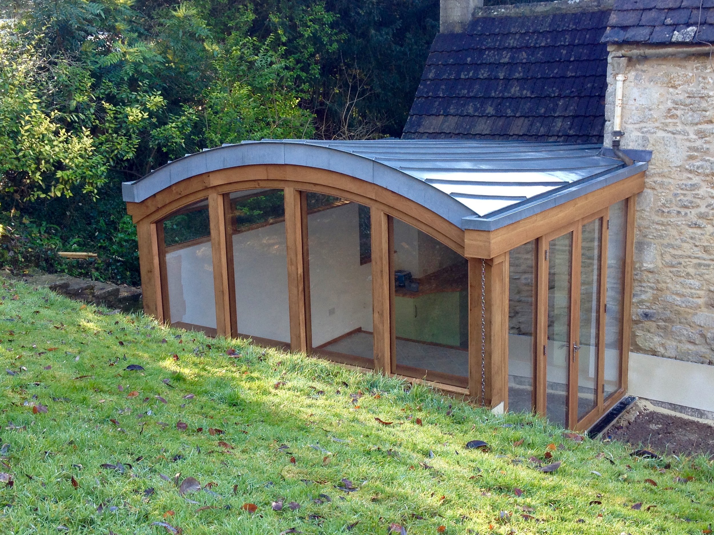 zinc, oak and glass extension on a listed building, Stroud, Cotswolds, Gloucestershire.