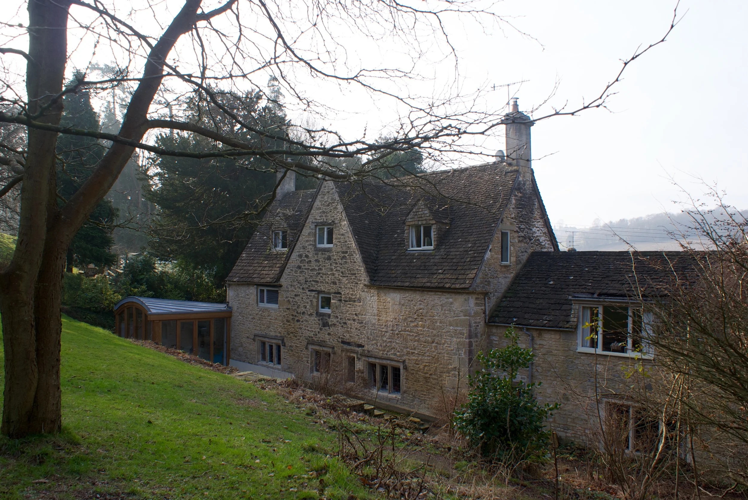 zinc, oak and glass extension on a listed building, Stroud, Cotswolds, Gloucestershire.