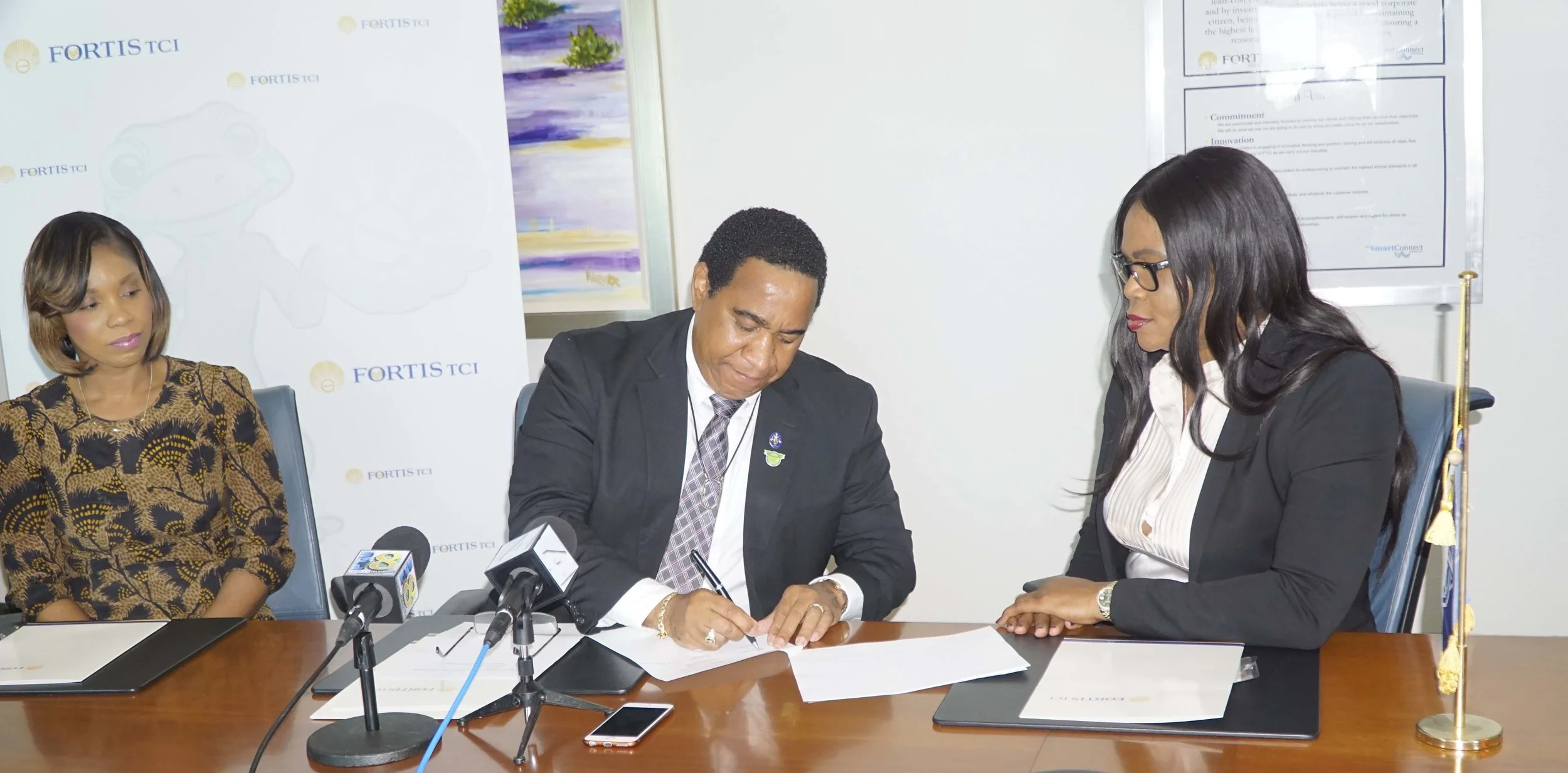 Signing of the contract by Fortis TCI President Eddinton Powell, and TCIFA President Sonia Bien-Aime, February 6, 2017