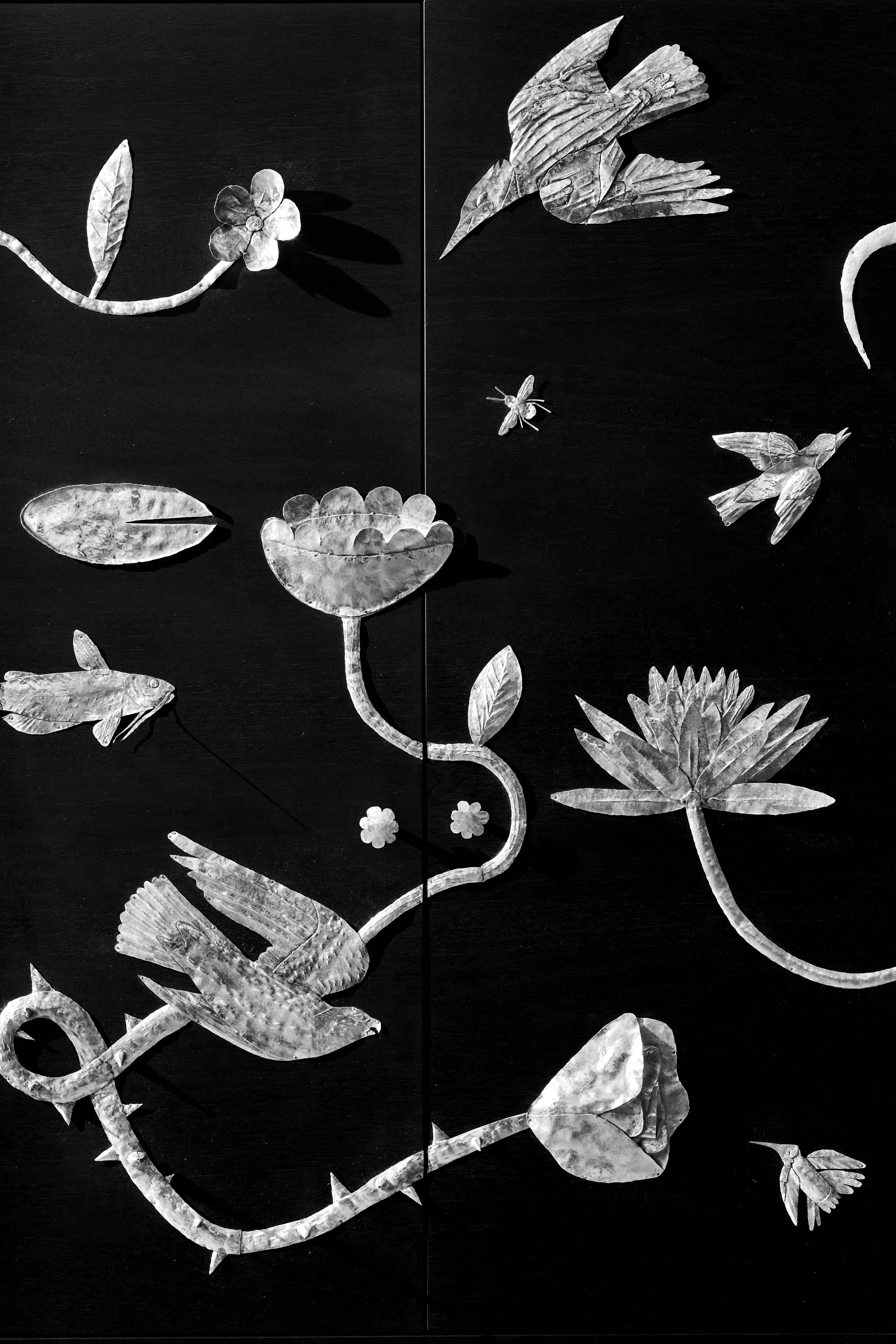 Ebonized walnut cabinet adorned in hand-chased, han-hammered silver motifs