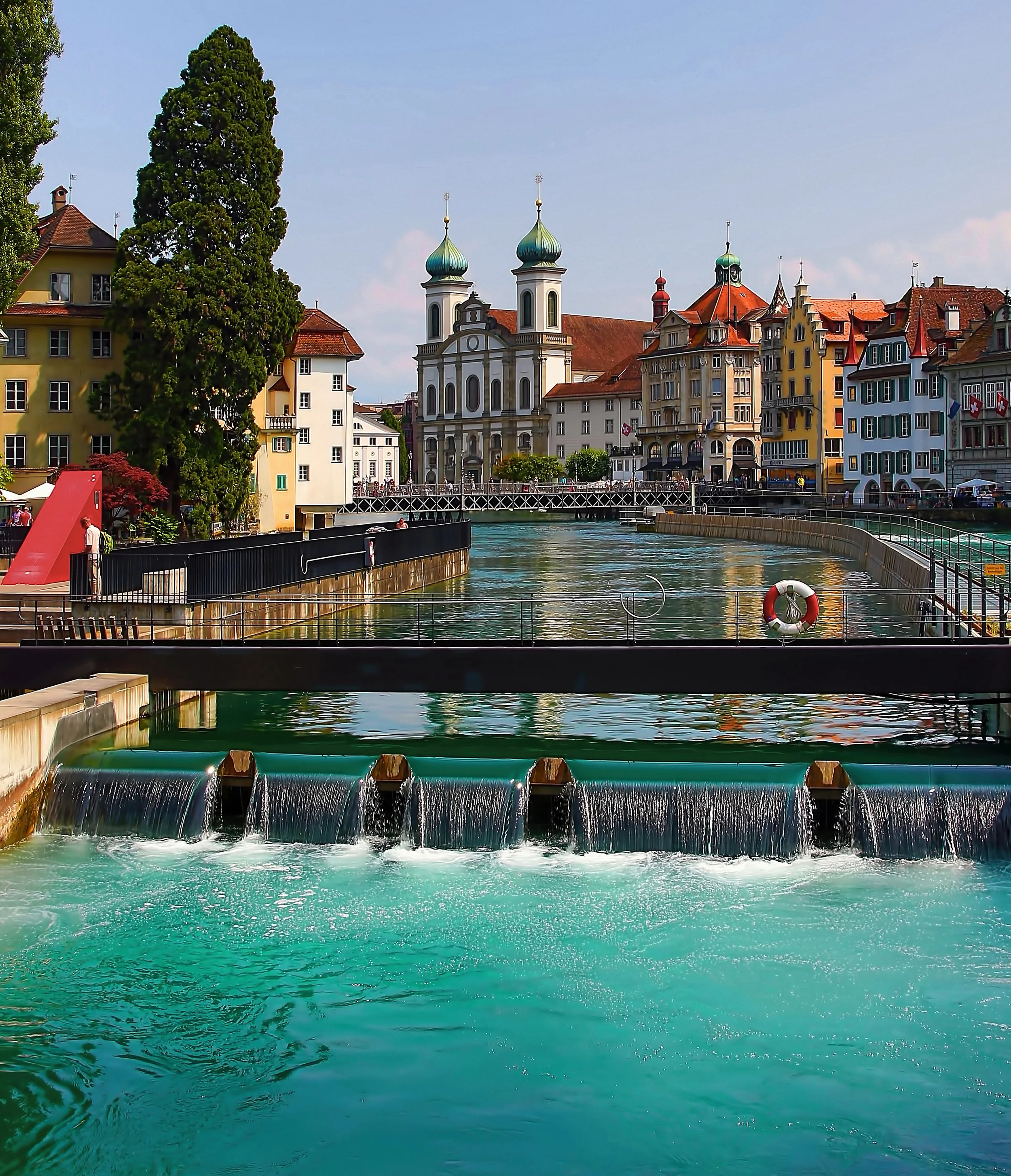 A strategically-engineered dam provides calming waterfall sounds in the middle of this city in Switzerland. / Image by Ricardo Gomez Angel via Unsplash
