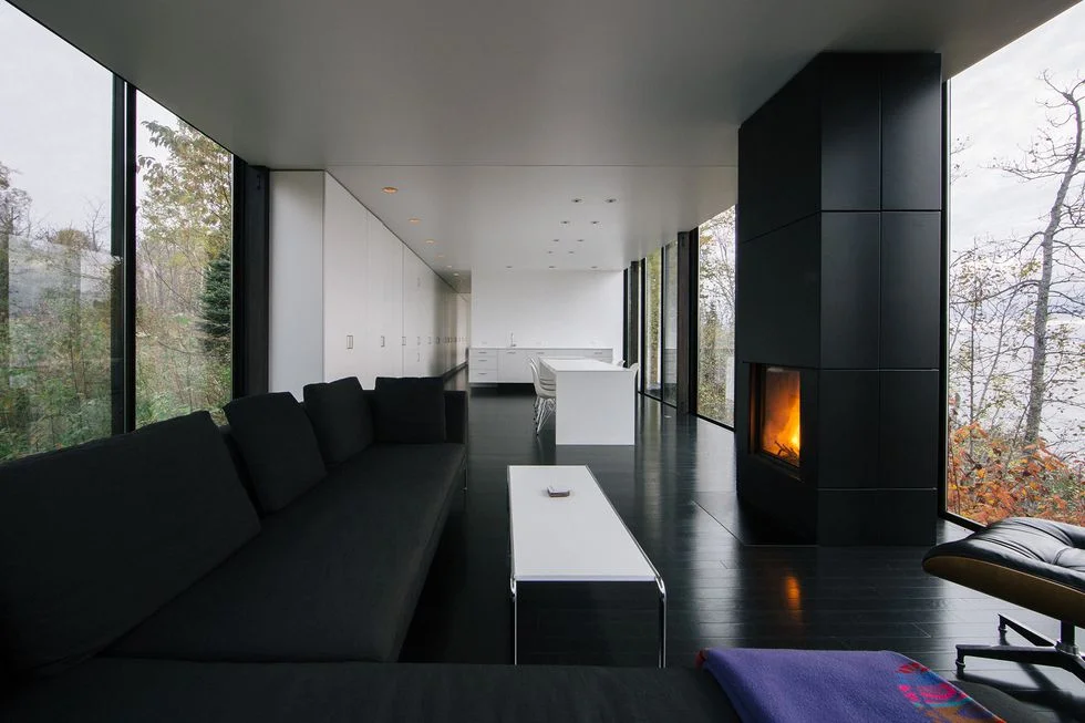 Chic and modern, this living room space provides endless views of the surrounding landscape. / Source