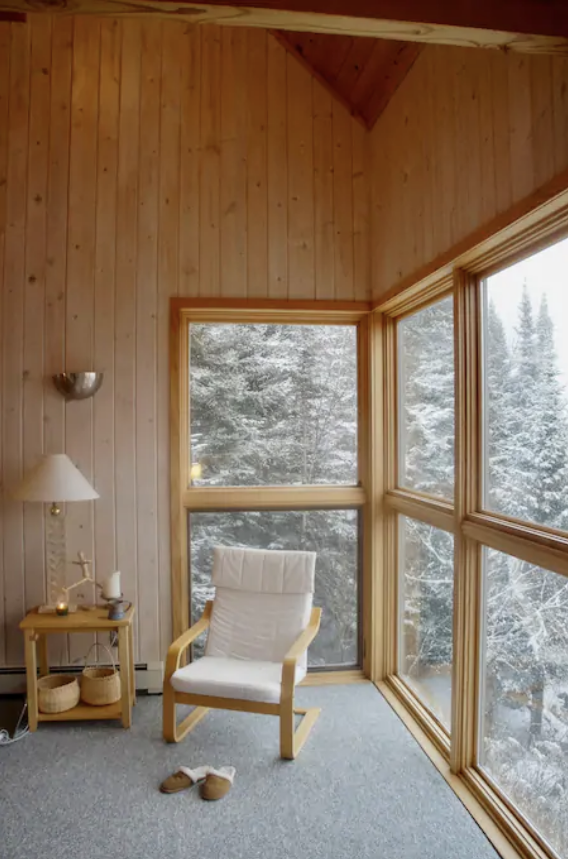 A cozy corner allows for pure relaxation as the snow gently falls among the surrounding trees. / Source