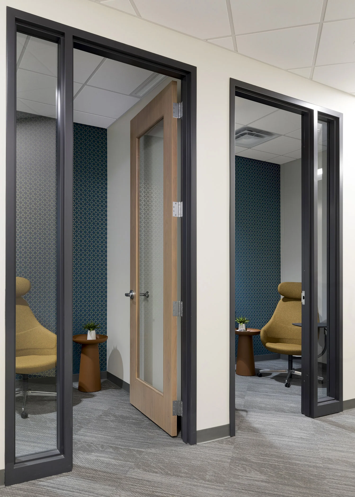 Small private rooms allow for confidential phone calls or a quiet personal work space. / Design by Vela Creative