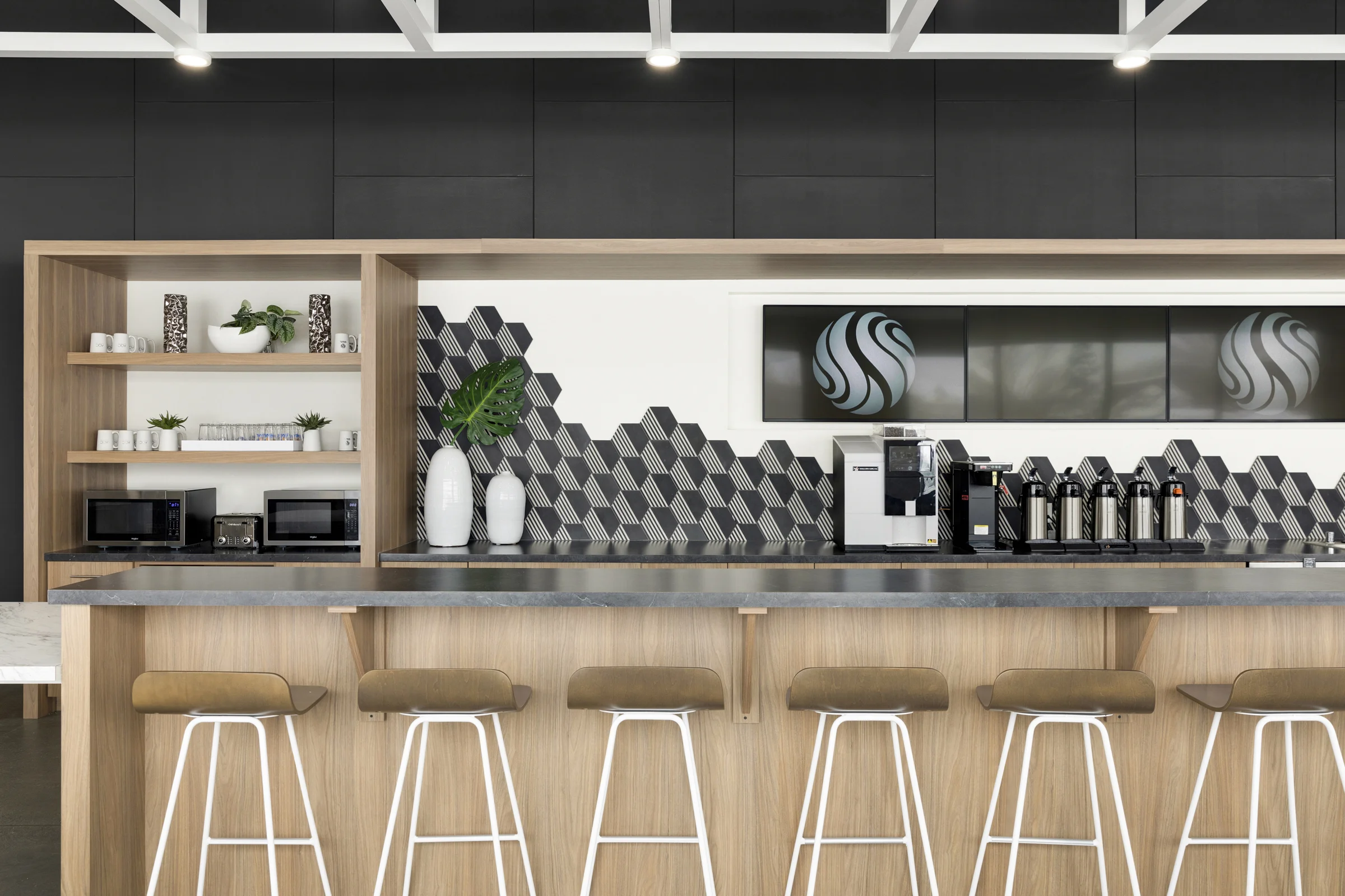 A shared open kitchen gives employees a space to both socialize and find nourishment. / Design by Vela Creative
