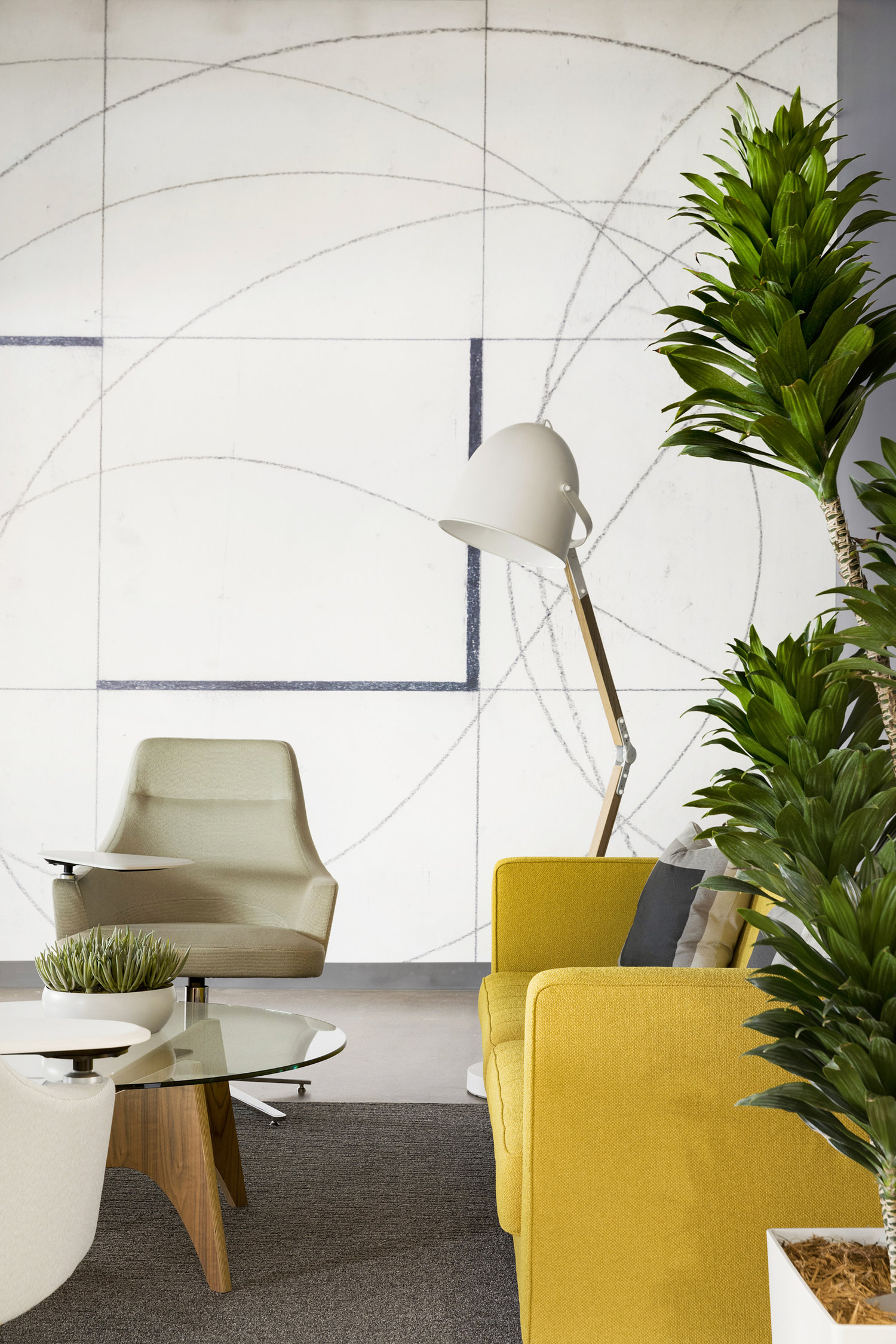 Plants surround this lounge area, pulling in touches of nature to make the space feel alive. / Design by Vela Creative
