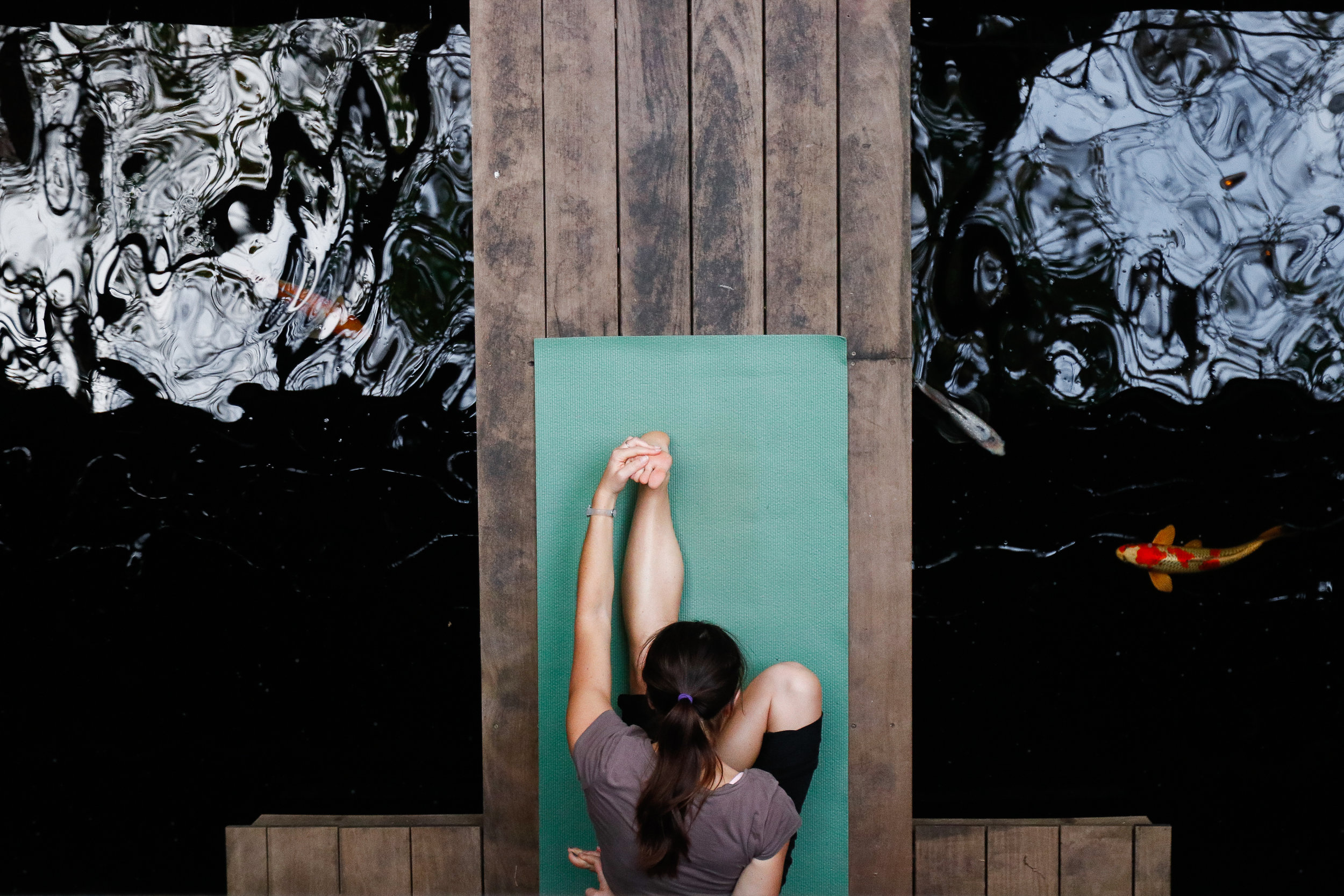 A woman holds her pose during a complimentary rocket yoga class hosted by M3 Yoga in the Tree Room in Athens, Ga., on Friday, Nov. 3, 2017. M3 Yoga owner, Nick Combs, opened shop in hopes of sharing the very practice that saved his life. After being diagnosed with degenerative disk disease, yoga became the only thing to ease Combs’ pain.