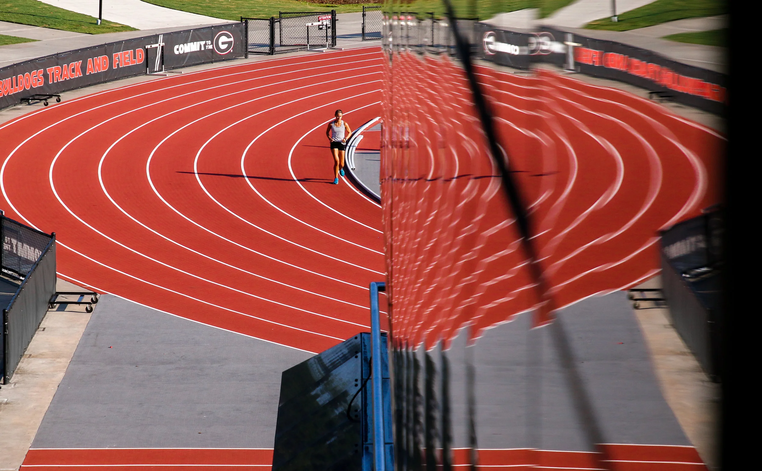 A runner jogs the inside curve of the Specs Towns Track in Athens, Ga., on Thursday, Aug. 9, 2018.