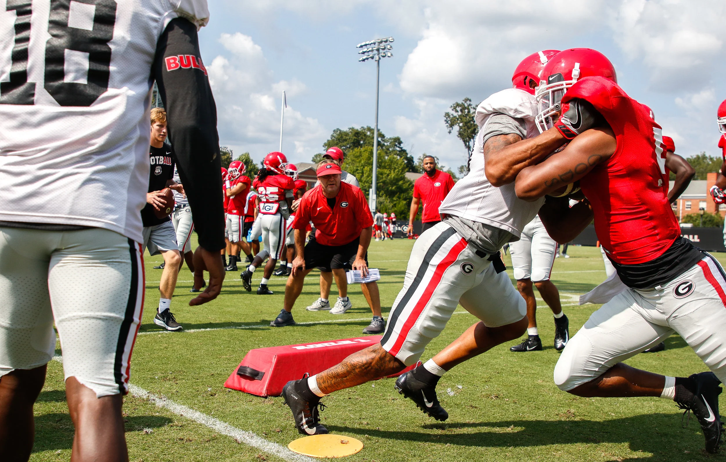Georgia head coach Kirby Smart observes Georgia defensive lineman Julian Rochester (5) go head-to-head with Georgia defensive back William Poole (31) during preseason practice in Athens, Ga., on Wednesday, August 22, 2018.
