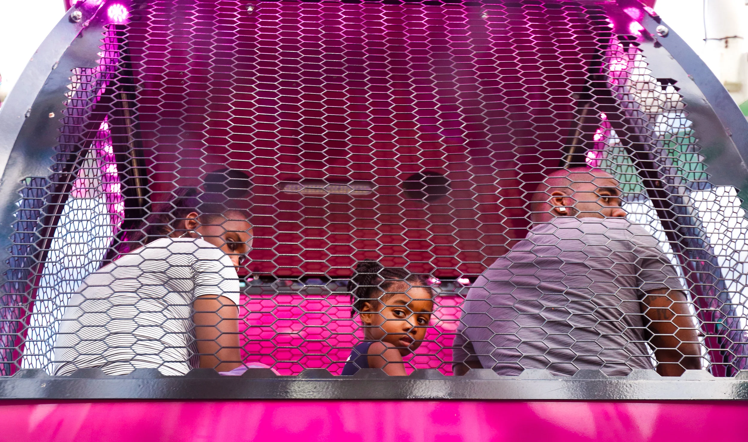 Peering back at the view, a family shares a sky bucket of a ferris wheel at the Georgia National Fair in Perry, Ga., on Saturday, Oct. 7, 2017.