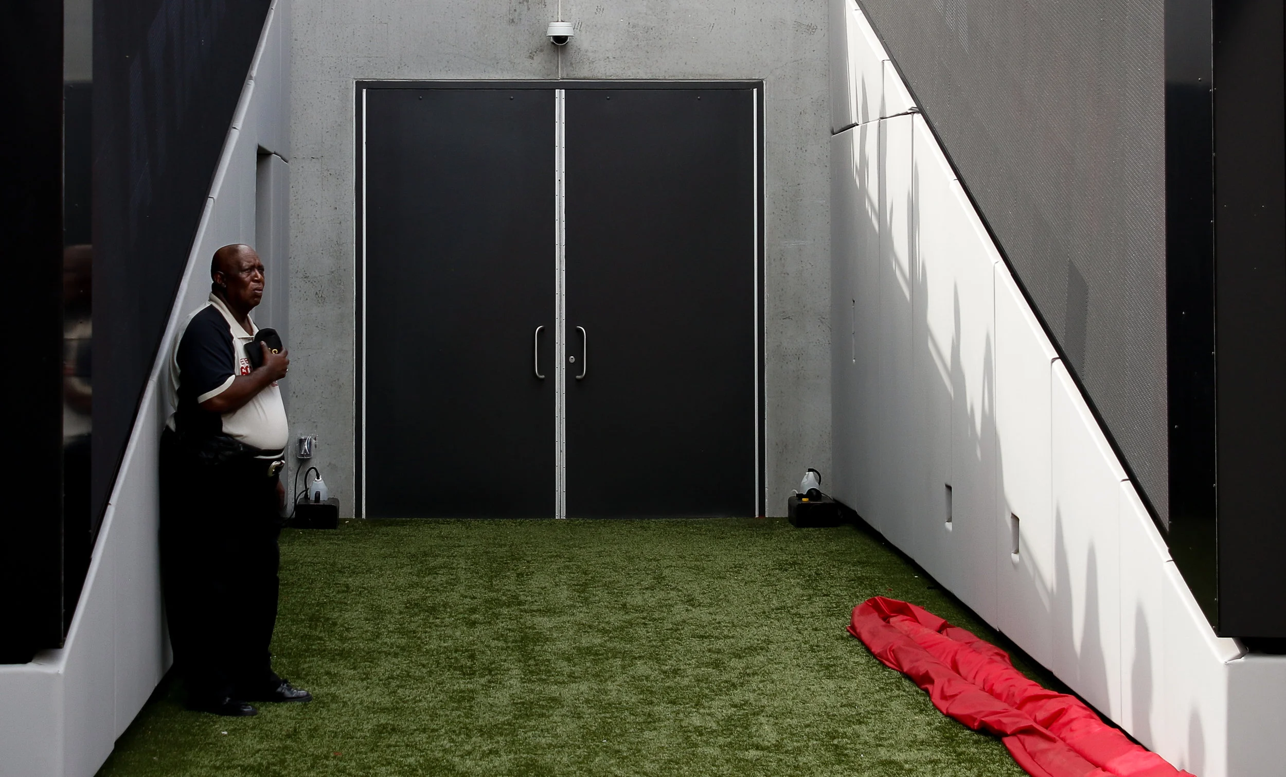 A member of the event staff stands outside of the Georgia Bulldogs’ locker room during the National Anthem in Sanford Stadium on Saturday, September 29, 2018.
