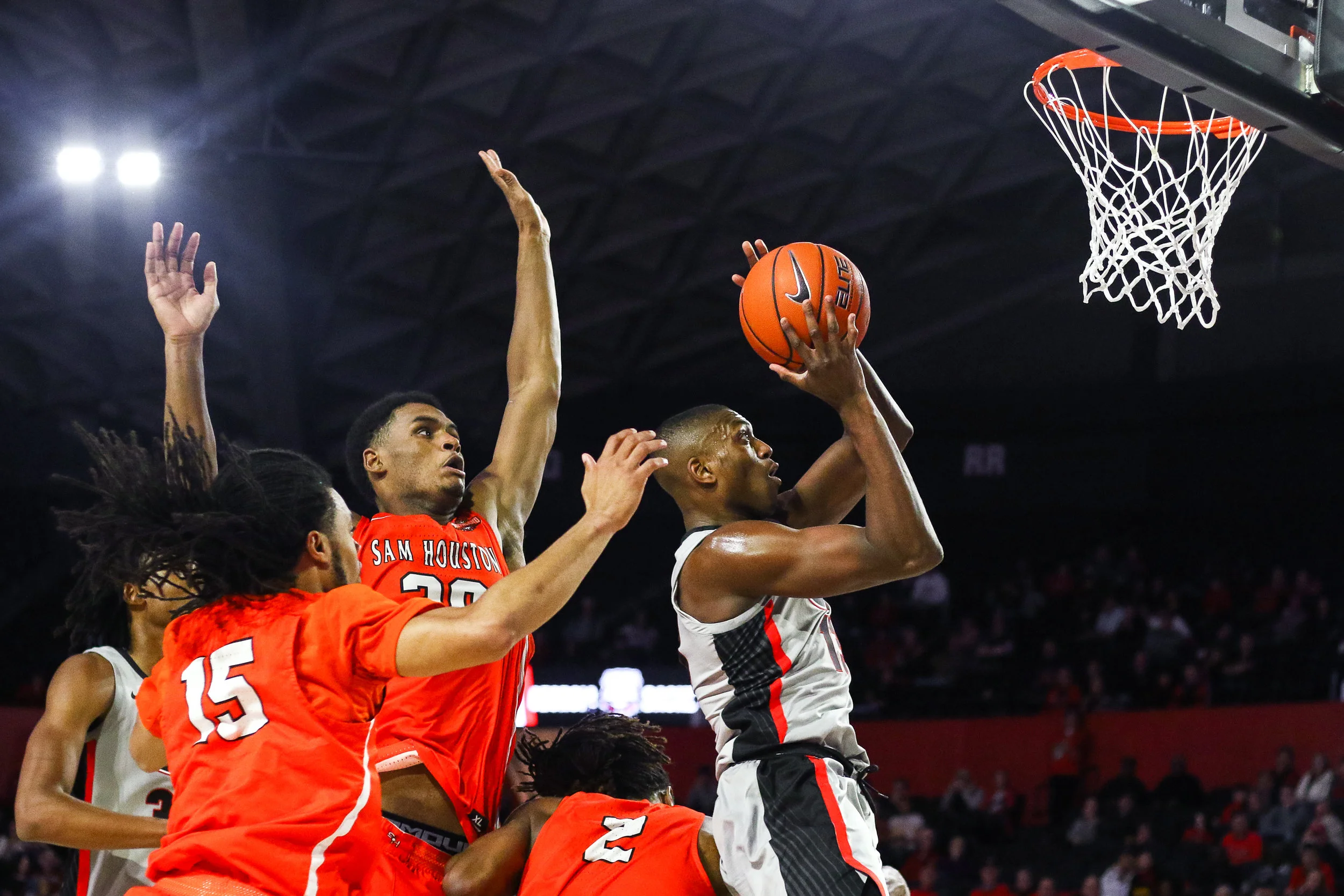Georgia forward E’Torrion Wilridge (13) attempts a layup as Sam Houston State forward Kai Mitchell (20) reaches for the block during the second half of the men’s basketball game between the Georgia Bulldogs and the Sam Houston State Bearkats in Steg