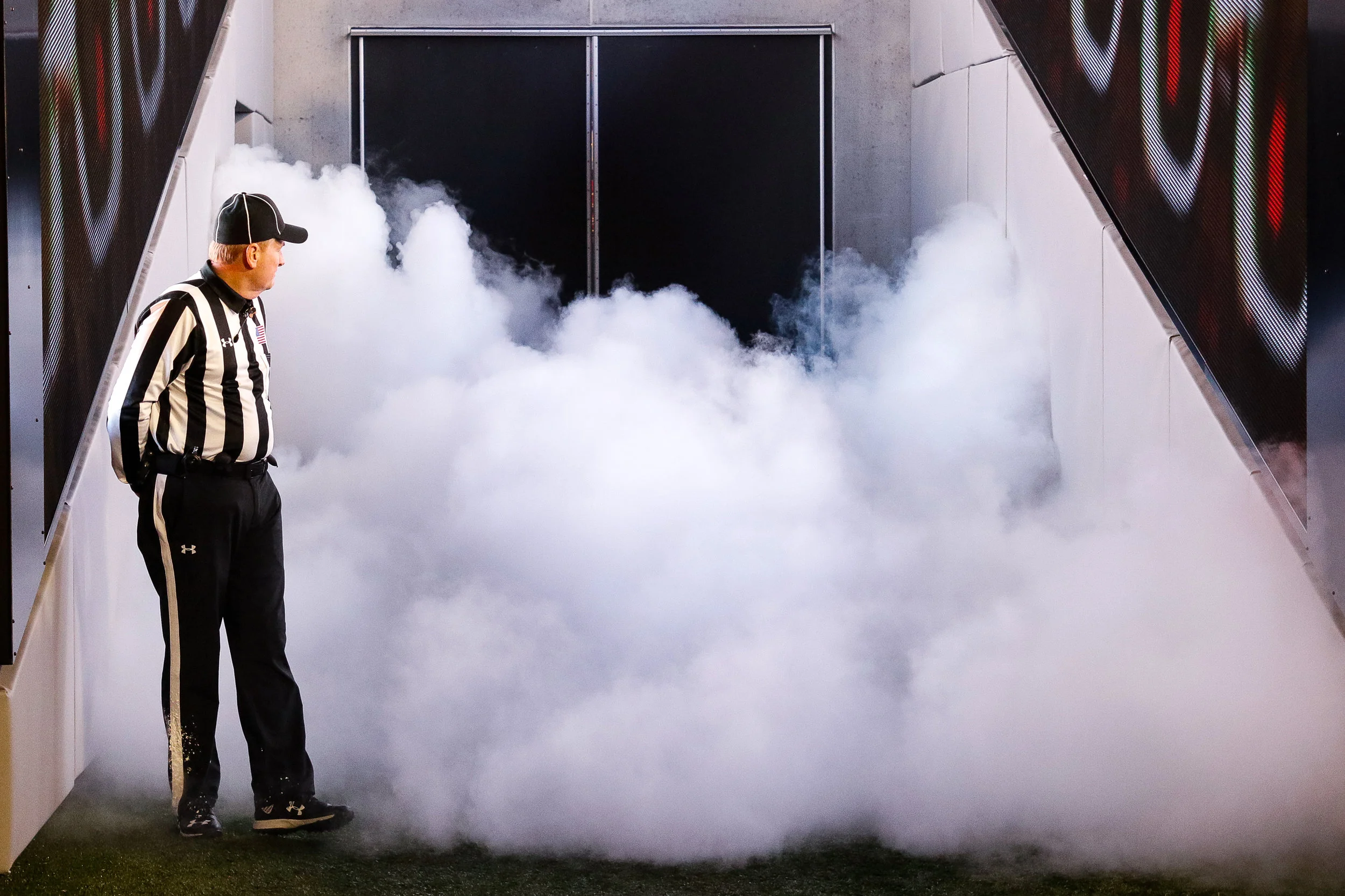 A referee double takes as smoke fills the tunnel, before the Georgia Bulldogs take the field for an NCAA football game between the University of Georgia and Auburn University in Sanford Stadium on Saturday, November 11, 2018.