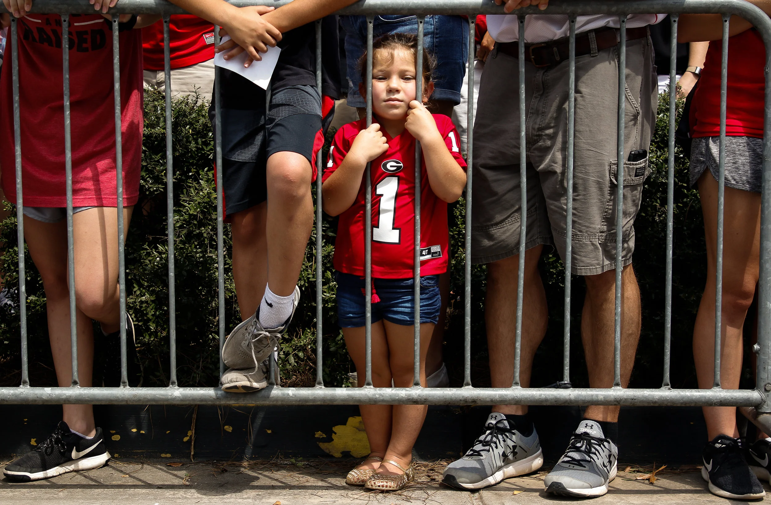 A young fan waits behind the barricade for the University of Georgia football team to arrive for their first Dawg Walk of the 2018 season in Athens, Georgia on Saturday, September 1, 2018.