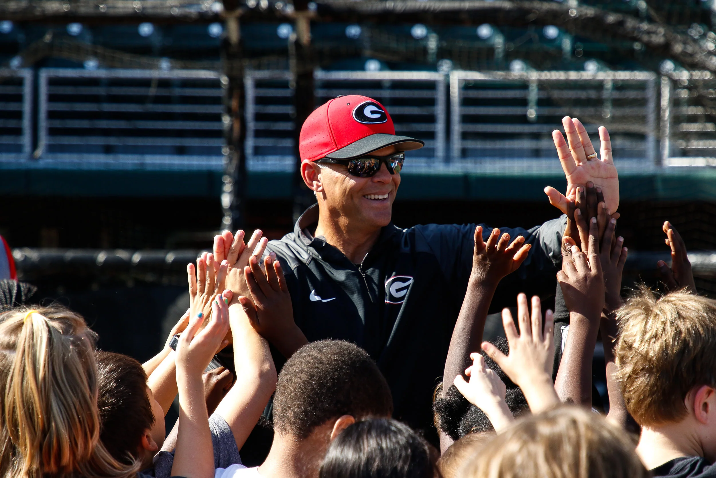 Georgia head coach Scott Stricklin high fives Barrow Elementary School students as the Georgia Baseball Halloween Practice comes to an end at Foley Field on Wednesday, October 31, 2018.