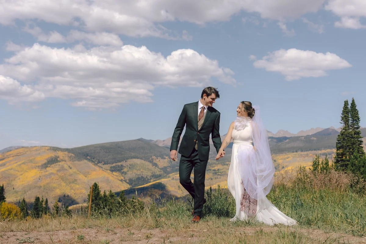 A bride and groom walk along the top of Vail Mountain before their Sonnenalp Wedding, Colorado photographer.