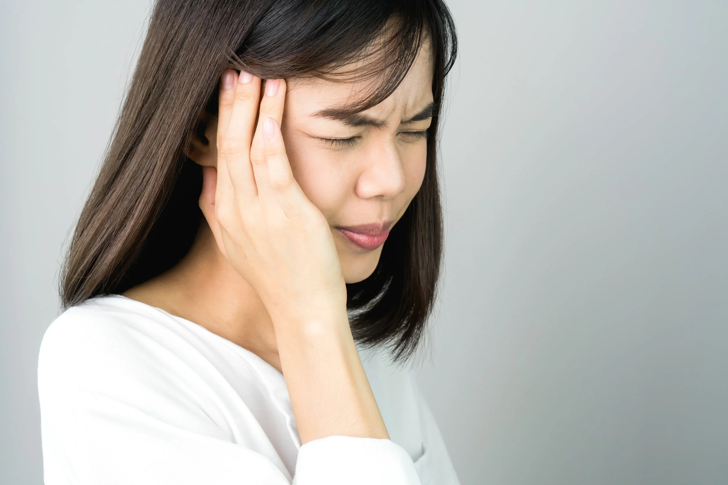 woman-in-a-white-dress-is-touching-head-to-show-her-headache-causes-may-be-caused-by-stress-or_t20_8lRQVQ.jpg