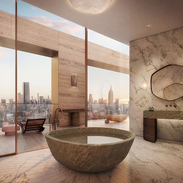 The ethereal master bath at @theXInyc West Tower Penthouse features a custom sandblasted verde caldia floor, a carved verde scuro tub, and bronze vanities with marble tops designed by #AD100 French interior architect @pierre.yovanovitch.

Situated in