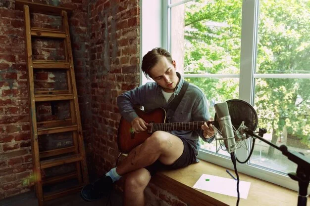 young-man-recording-music-video-blog-home-lesson-song-playing-guitar-making-broadcast-internet-tutorial-while-sitting-loft-workplace-home-concept-hobby-music-art-creation_155003-25284.jpg