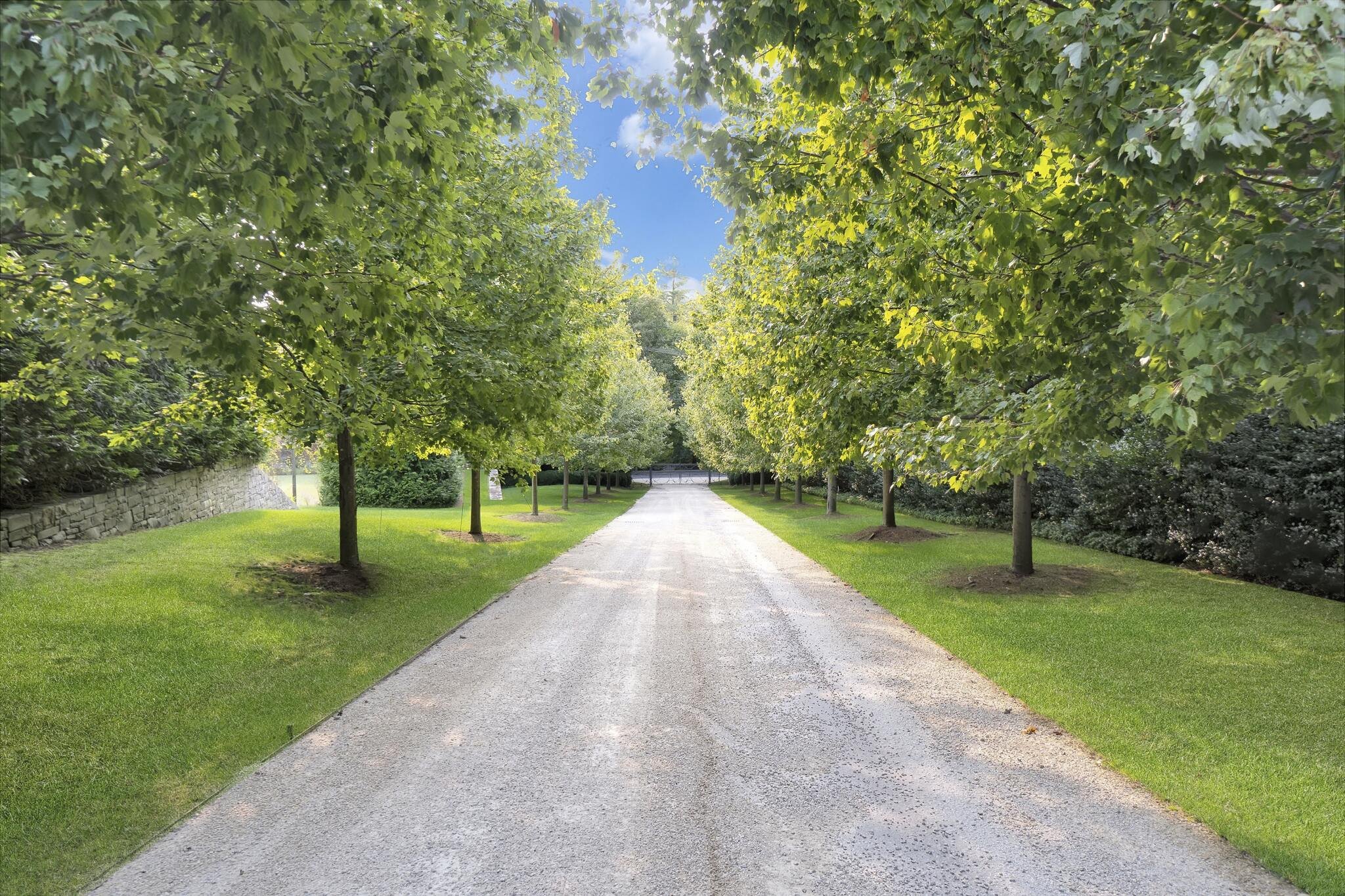  Enter the tree lined gravel driveway to one of the most elevated lots in Greenwich, with views of Long Island Sound from multiple rooms. A light filled first floor features a grand entry hall leading to a superb office with bathroom, bar, and exteri