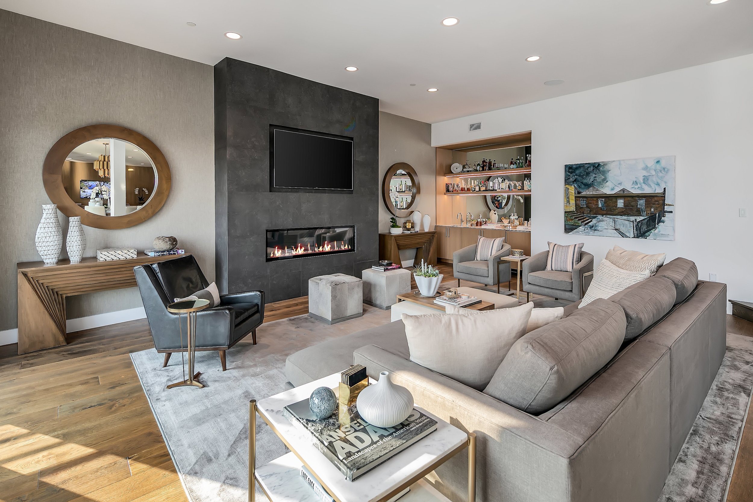  The main living area is an entertainer's dream boasting an open floor plan, high ceilings, and an abundance of natural light. From the great room with a custom wet bar, sliding glass doors open to an expansive outdoor deck allowing for quintessentia