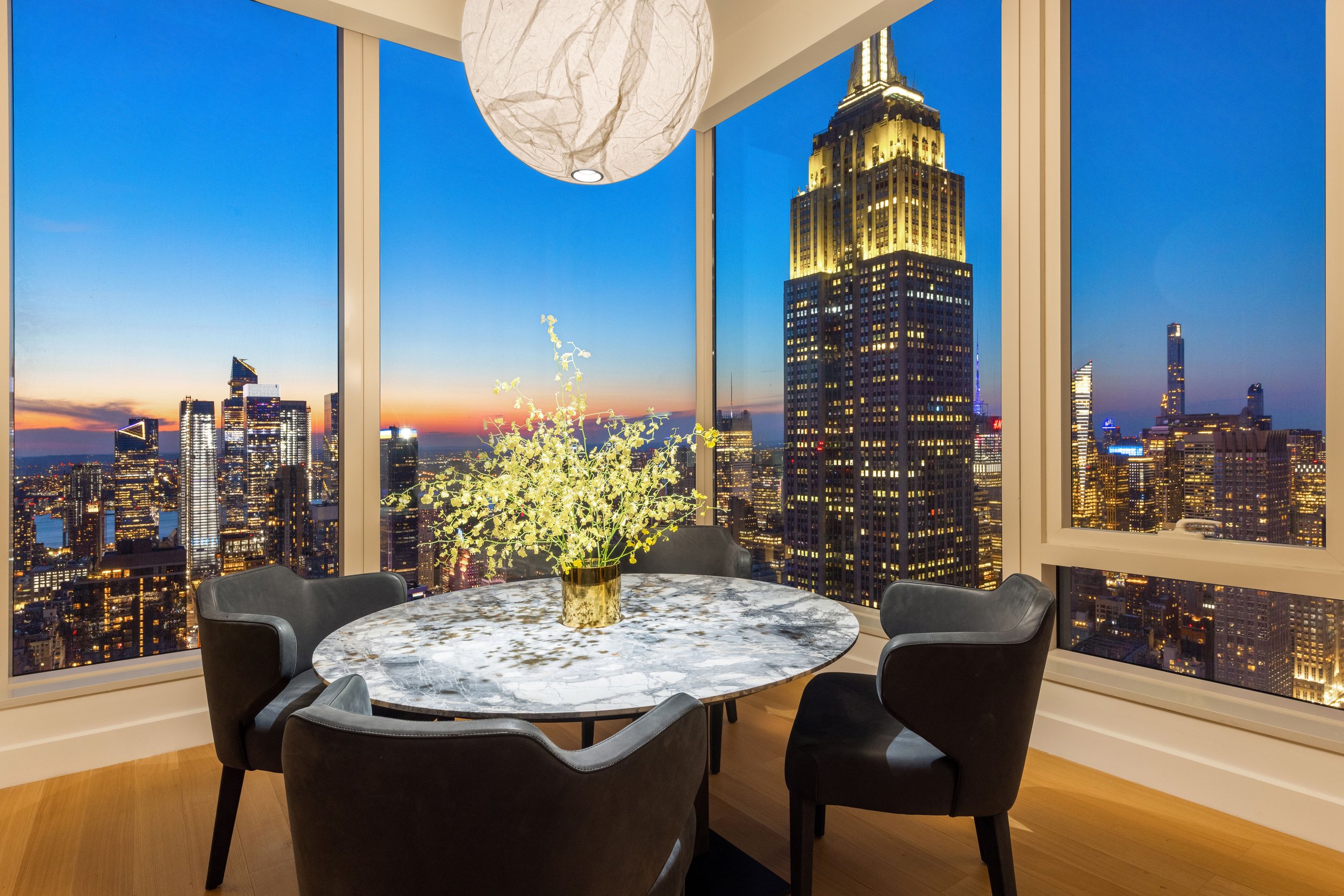  This 3,391 square foot four-bedroom, four and a half-bath residence opens into an elegant entry foyer, leading to a living and dining room encased with 10-foot tall windows with North, East and West views. Gachot-designed custom rift-cut cabinetry a