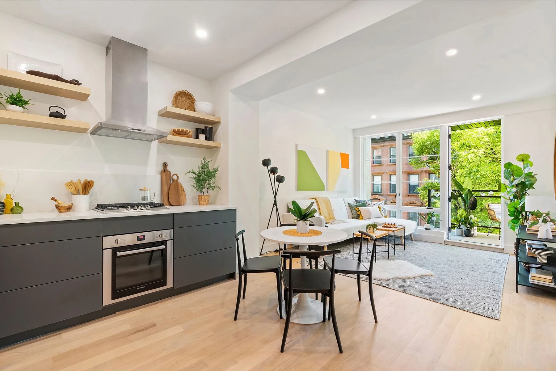  Open kitchens at 26 W 127th Street have been generously appointed with Bosch counter-top stoves and oven, and Liebherr refrigerators. Custom matte-gray, soft-touch cabinets sit below the quartz countertop while five-inch-thick floating oak shelves o